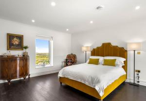a bedroom with a large bed and a window at Sweet Garden, Mannin - Ballyconneely in Ballyconneely