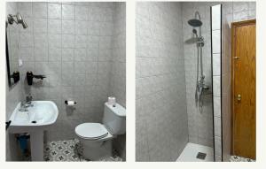 a bathroom with a toilet and a sink and a shower at Casa la Torre in Zahara de la Sierra