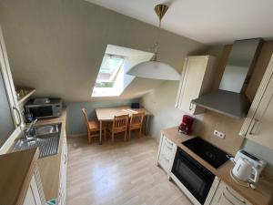 a small kitchen with a table and a dining room at Silvia Busche in Obernkirchen