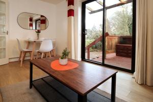uma sala de estar com uma mesa de madeira e uma sala de jantar em 2 Bedroom GF Home - Private Parking and Garden em Lancaster