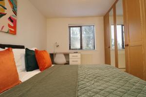 a bedroom with a bed and a desk and window at 2 Bedroom GF Home - Private Parking and Garden in Lancaster +11 photos