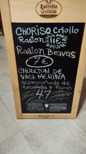 a chalkboard sign with a menu for a restaurant at HOTEL RURAL LOS FAROLES in Huérmeces