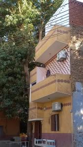 a building with two balconies on the side of it at charming nubian guest house in Aswan