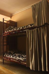 two bunk beds in a room with a curtain at Everyday Cat Hostel in Batumi