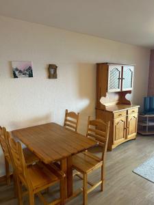 a dining room with a wooden table and chairs at Bellevue PLEASANT & COMFORTABLE apartments in Veysonnaz