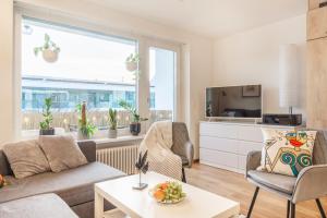 Special PICCO PICASSO Apartment Basel, Bahnhof Grossbasel 10-STAR في بازل: غرفة معيشة مع أريكة وطاولة