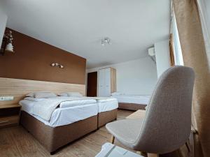 a bedroom with a bed and a desk and a chair at Family Hotel "Slavianska dusha" in Veliko Tŭrnovo