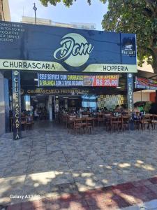 a restaurant with tables and chairs on a street at MAR & SERRA - PRAIA do MORRO in Guarapari