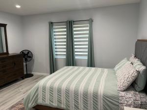 a bedroom with a bed and a dresser and a window at Lovely 2bedroom next to Santa Monica college in Los Angeles