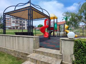 a playground in a park with a slide at Апартамент Sunny home in Chernomorets