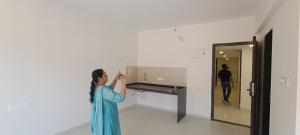 een vrouw die een foto neemt van een muur in een kamer bij Indilife nature in Pune