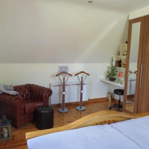 a bedroom with a bed and a couch and a chair at Mizen View in Goleen