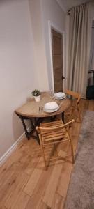 a wooden table and chairs in a living room at 3 Bed Home in Heart of Cardiff in Cardiff