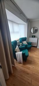 a living room with a couch and a table at 3 Bed Home in Heart of Cardiff in Cardiff