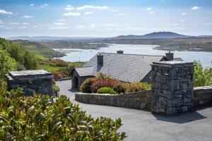 a stone house with a view of a lake at Once Upon a Tide in Clifden