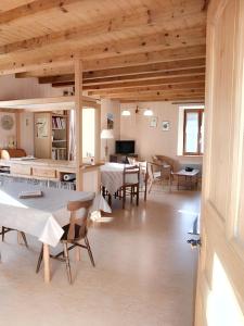 a large room with tables and chairs in a building at Appartement de 3 chambres avec jardin amenage et wifi a Plancher les Mines a 7 km des pistes in Plancher-les-Mines