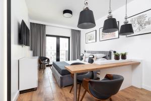 a living room with a bed and a table at Studio with a balcony and AC - Rajska 3 street in Kraków