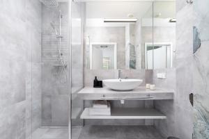 a bathroom with a sink and a shower at Studio with a balcony and AC - Rajska 3 street in Kraków