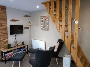 a living room with a staircase and a chair at Maison Luz-Saint-Sauveur, 3 pièces, 4 personnes - FR-1-402-130 in Luz-Saint-Sauveur