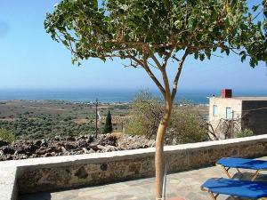 a table and a tree on a patio with a view at Patsianos Traditional House in Frangokastello