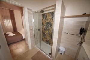 a shower with a glass door in a bathroom at Maralbé Guest House in Messina