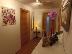 a hallway with a vase and a painting on the wall at Ferienwohnung Mayrhofer in Innerschwand am Mondsee +21 photos
