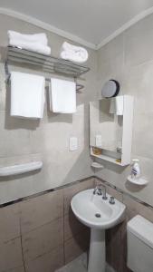 a white bathroom with a sink and a toilet at Departamento en Ruta del Vino*4m Bodegas López*Maipú in Maipú +50 photos