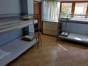 een kamer met 3 stapelbedden en een raam bij Hostel Varna Botanika in Varna