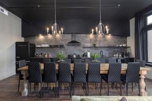 Penthouse Grand Executive Suite في لويزفيل: غرفة طعام مع طاولة وكراسي خشبية كبيرة