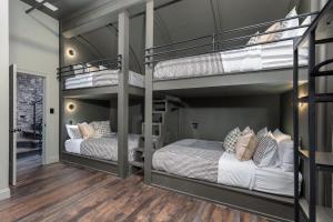 two bunk beds in a room with wood floors at Penthouse Grand Executive Suite in Louisville