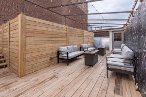 a patio with couches and chairs on a wooden deck at Penthouse Grand Executive Suite in Louisville