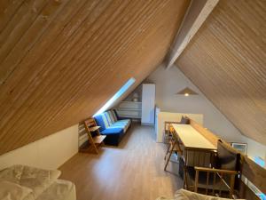 a room with a loft with a table and a couch at Holiday home in resort in Skagen with public pool in Skagen