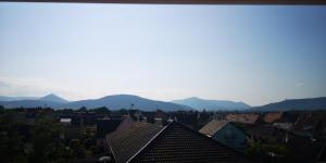 a view of a city with mountains in the background at Cocon sous les toits - vue sur les châteaux et le vignoble - proche centre ville - parking gratuit in Sélestat