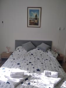 a bedroom with a bed with a comforter on it at Jelka in Sremski Karlovci
