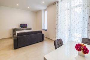 a living room with a table and a couch at Camilla's Home in Chiavari +6 photos