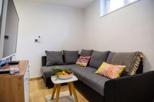 a living room with a couch and a bowl of fruit on a table at Apartment Zvoncac in Split +6 photos