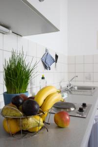 a bowl of fruit on a counter in a kitchen at Pension Krone in Schwäbisch Gmünd