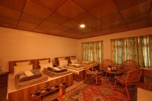 a living room with a couch and a table at Karma Lodge in Leh