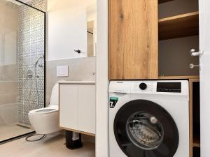 a small bathroom with a washing machine in it at Sublime Bnb in Shkodër +251 photos