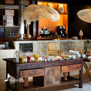 a table with food and drinks on top of it at Hotel Ponta do Madeiro in Pipa