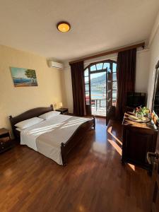 a bedroom with a bed and a large window at Villa Samac in Trogir