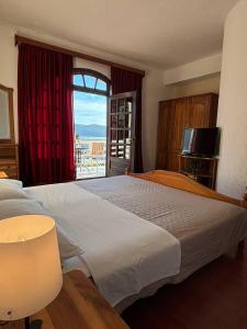 a hotel room with a large bed and a window at Villa Samac in Trogir