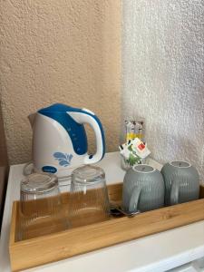 a tray with a tea pot and glasses on a counter at Villa Samac in Trogir