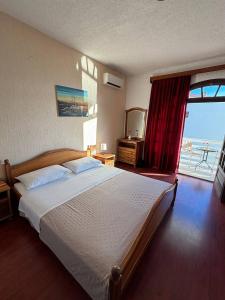 a bedroom with a bed with a view of the ocean at Villa Samac in Trogir