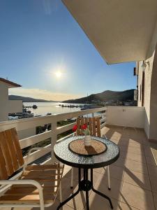 a table on a balcony with a view of the ocean at Villa Samac in Trogir