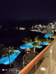 a view from the balcony of a resort at night at Sifah Inn in As Sīfah