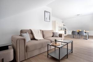 a living room with a couch and a table at Schöne Apartments in Lengerich I home2share in Lengerich