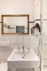 a bathroom with a white sink and a mirror at Studio an der Therme in Baden-Baden