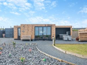 a wooden house with a patio in front of it at Galloway Views - Uk46816 in Wigtown