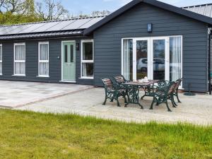 a patio with a table and chairs in front of a house at Stable Cottage - Uk45134 in Barnby